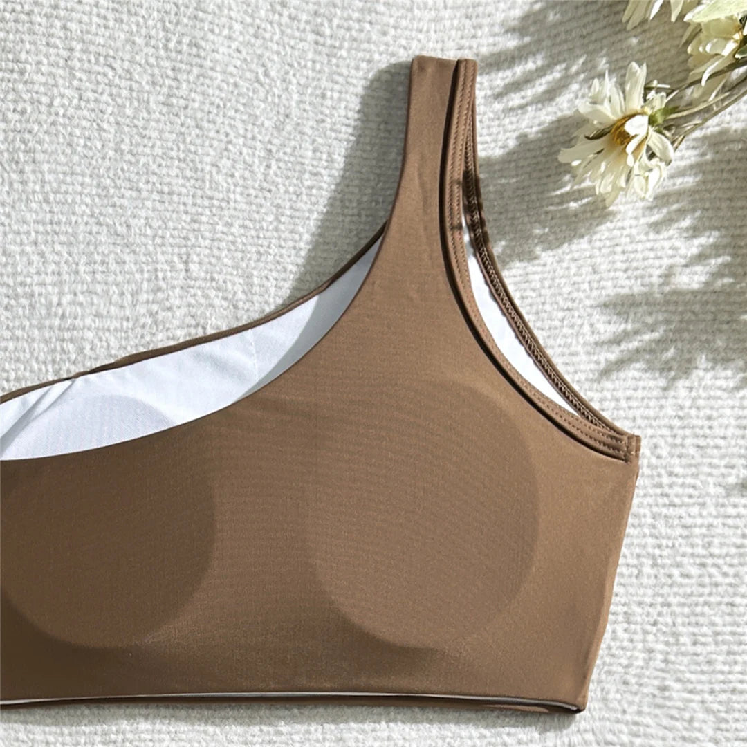 Wrinkled one-shoulder high waist bikini set, distinctive design, polyester spandex blend, wire-free support, women's solid two-piece swimwear, modern elegance and comfort.