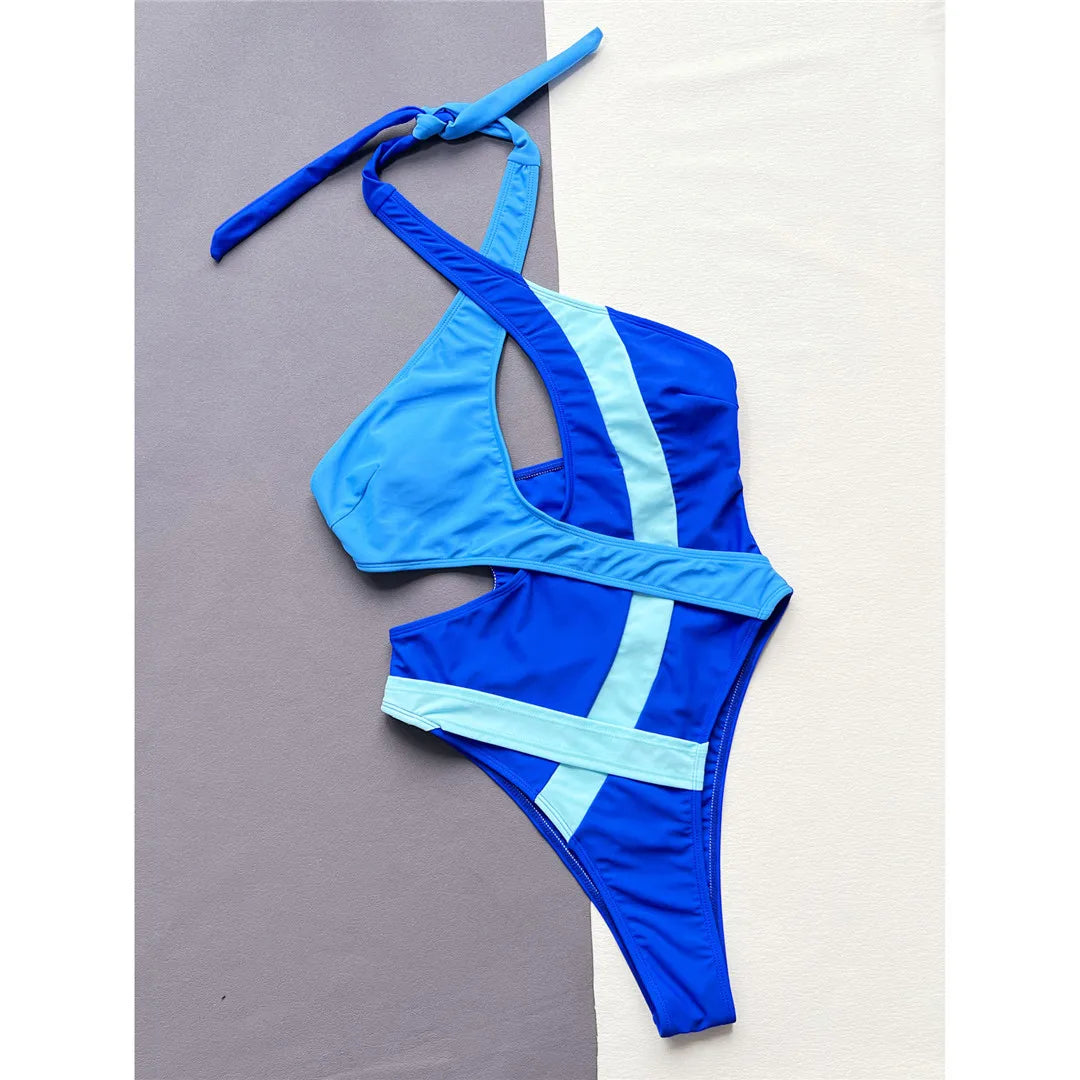 Blue Asymmetric Splicing Halter One-Piece Swimsuit with Backless Monokini Design. Unique Patchwork of Nylon and Spandex, Fits True to Size. Available in Sizes S, M, and L. Free Support with Padded Design. Perfect for Women and Adults. The product is in Stock with Free Shipping included.
