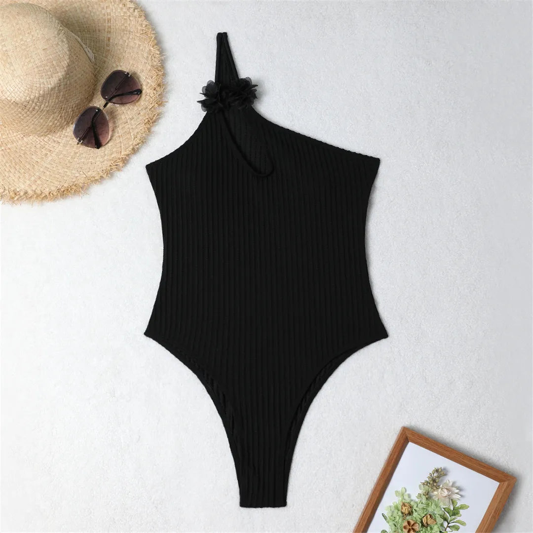 Elegant One-Shoulder One-Piece Swimsuit for Women, Adorned with Delicate 3D Flowers, Features a Cut-Out Design and Ribbed Texture, High-Leg Cut, Fits True to Size, Available in Sizes S to XL, Material: Nylon and Spandex, Solid Pattern, Available in Black and White, Perfect for Modern Feminine Style, Includes Padding