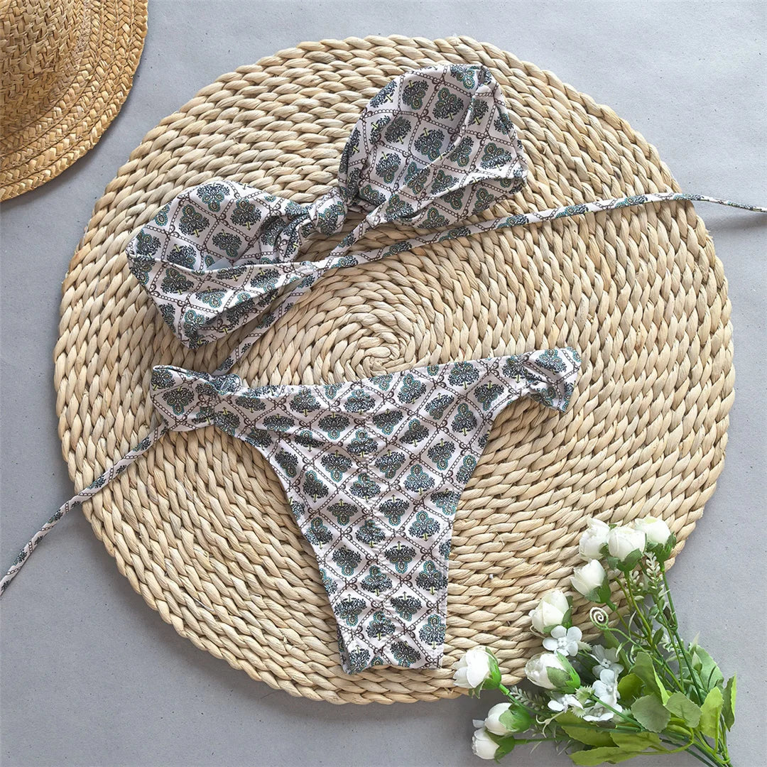 Printed bandeau knotted bikini set, high-leg design, polyester spandex blend, wire-free support, low waist, women's two-piece swimwear, trendy design with playful print.