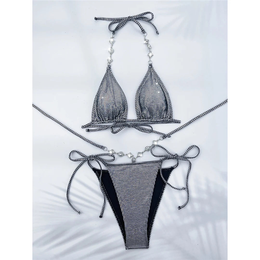 Sparkling diamond rhinestones halter bikini set in silver for women. This luxurious two-piece swimwear is made from Nylon and Spandex. Features a low waist design with wire free support. This solid pattern bikini fits true to size and comes with a pad. Available in sizes XS, S, M, and L. Offers free shipping on this classic yet glamorous swimwear, ideal for women aged 18 to 35.