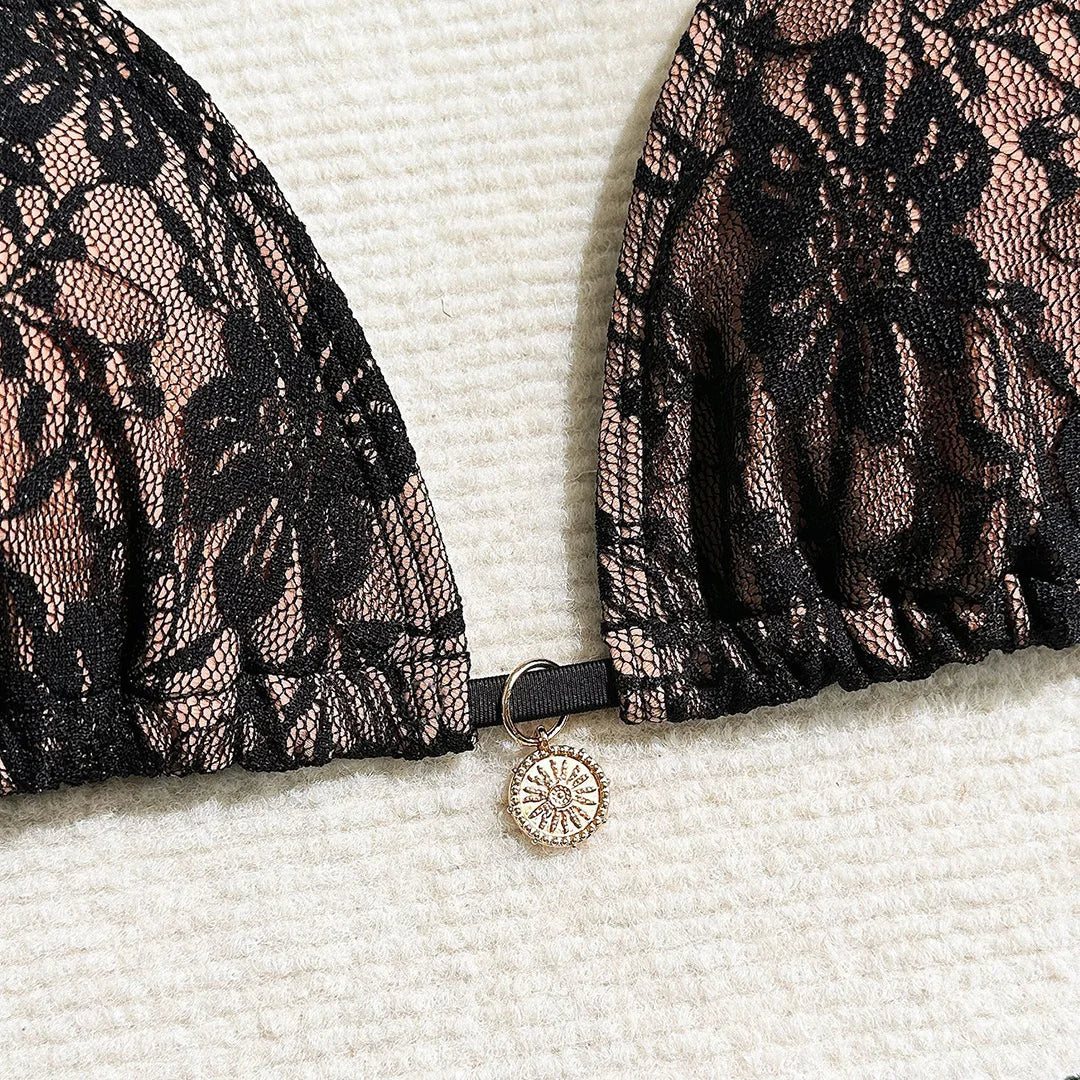 Three-piece bikini set featuring a lace halter top, high cut bikini bottoms, and mesh sarong in solid colors for an elegant and alluring beach look.