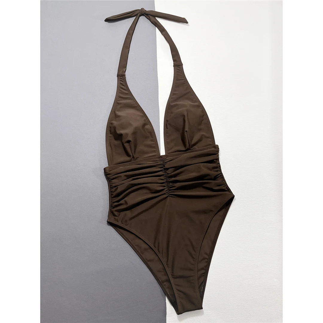 Striking Halter Monokini for Women, Features a Deep V-Neck and Unique Wrinkled Texture, High-Leg Cut, One-Piece Swimsuit, Fits True to Size, Available in Sizes S to XL, Material: Nylon and Spandex, Solid Pattern, Comes in Dark Brown, Brown, and Multicolor Options, Ideal for a Statement in Sophistication, Includes Padding