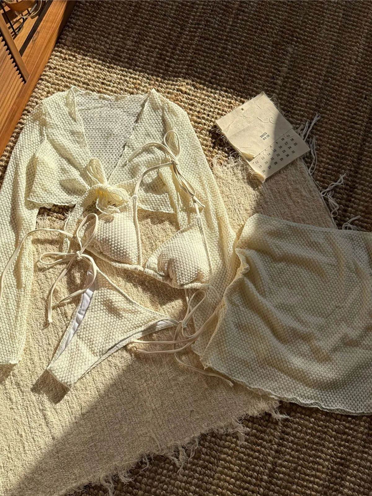 Long sleeve halter bikini four-piece set for women with chic mix-and-match options, including solid low waist design and matching skirt.