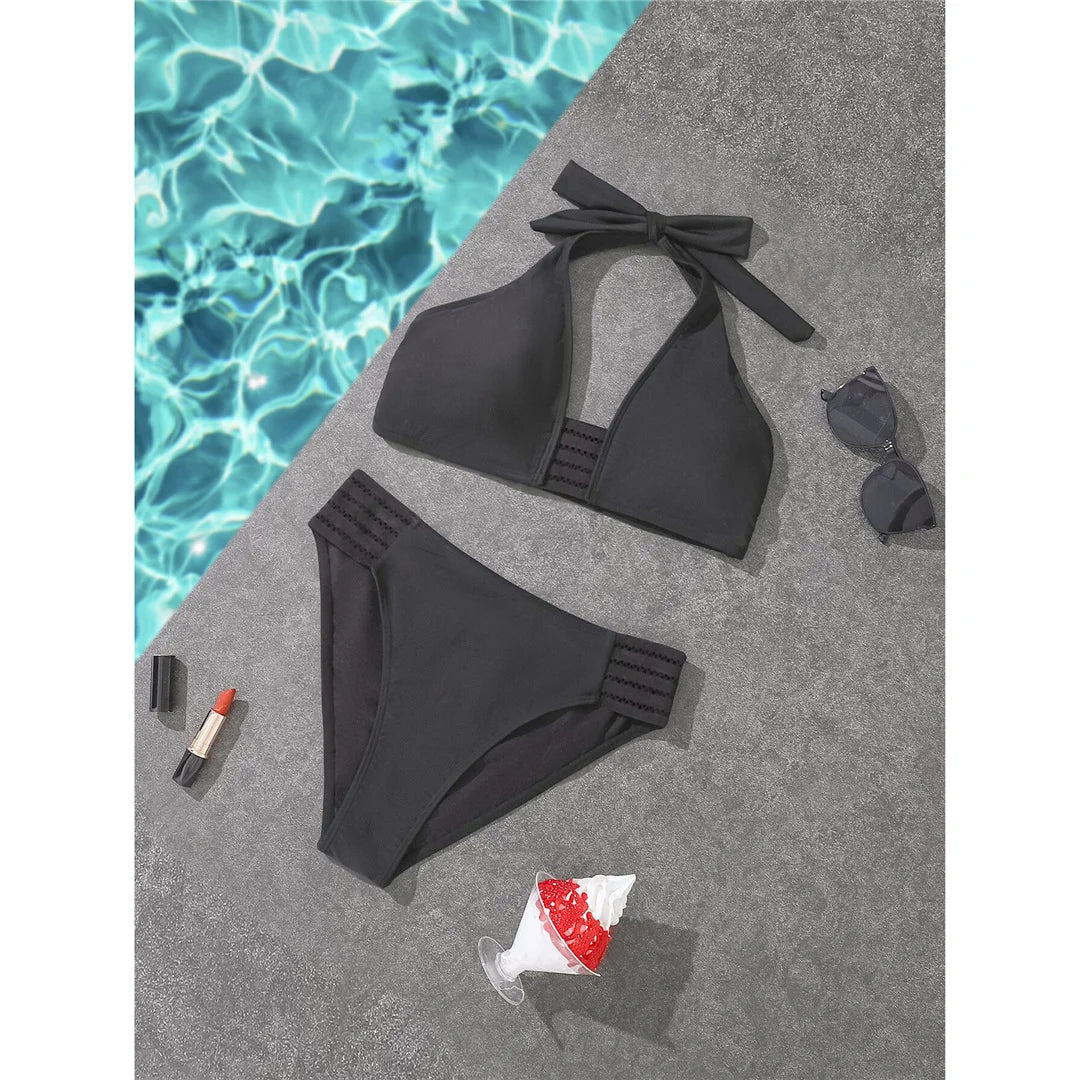 Halter mid-waist black bikini set with padded support for a timeless and elegant swimwear option for women.