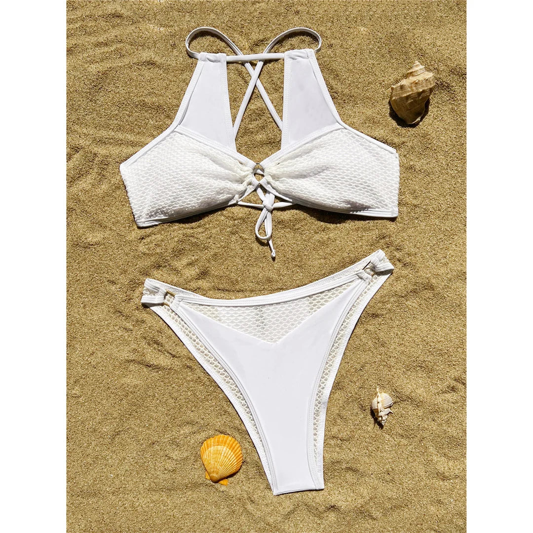 Captivating cut-out splicing bikini set in white for women. Comes with a complementary sarong, making this a versatile three-piece ensemble. Made of Nylon and Spandex with wire free support. Low waist design with a solid pattern, fits true to size, and includes a pad. Available in sizes XS, S, M, and L. Offers free shipping on this perfectly elegant beachside attire. Suitable for women aged 18 to 35.