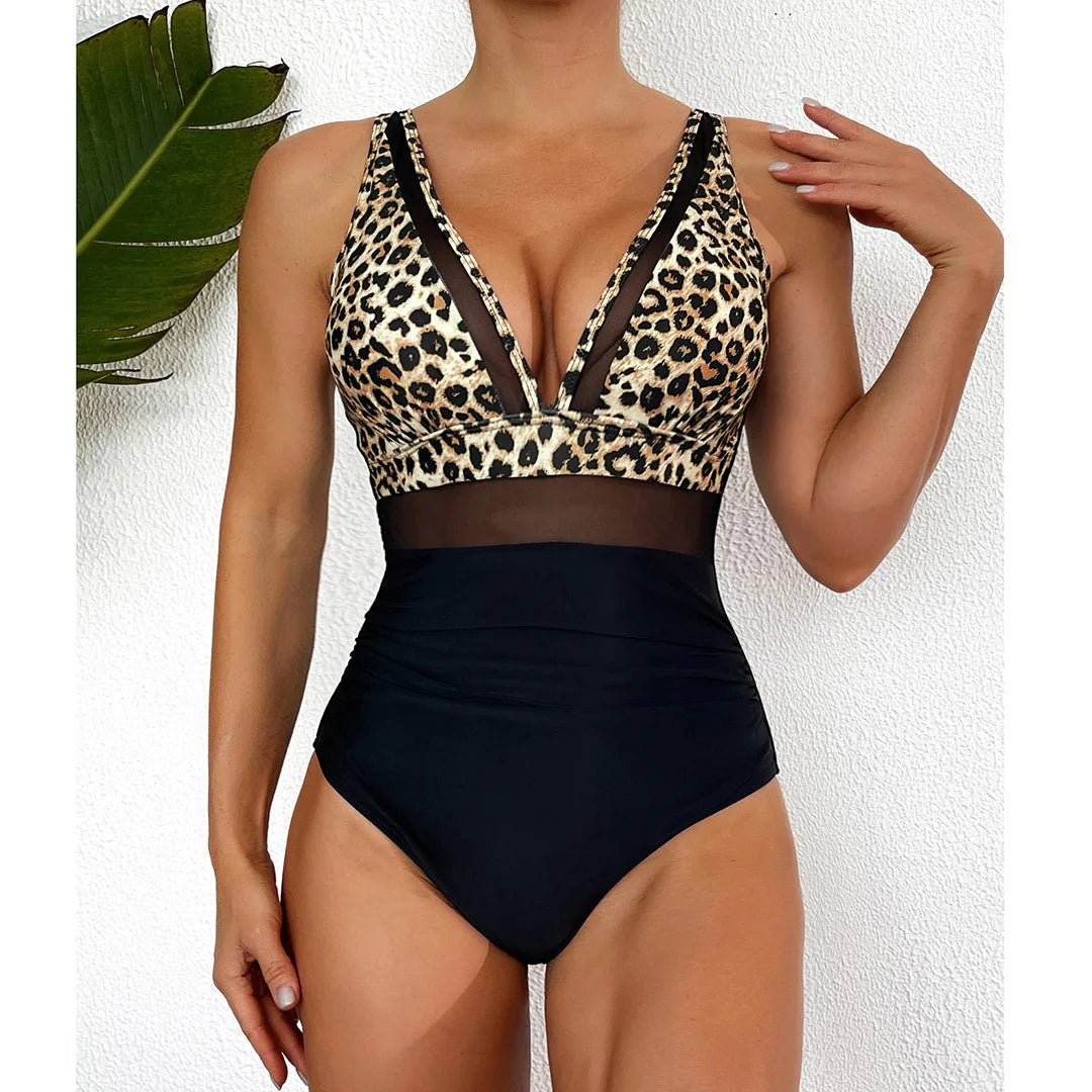 Mesh Sheer V Neck Leopard Printed One Piece Swimsuit available in sizes S to XL. Made of Nylon and Spandex, this one-piece swimsuit or monokini features sheer mesh detailing and a bold leopard print. With its deep V neck and flattering silhouette, it is perfect for making a striking impression at the pool or beach. Available in Black, Deep Blue, Hot Pink, Red, White, Dark Green, Green, Leaves, Leopard, and Multicolor.