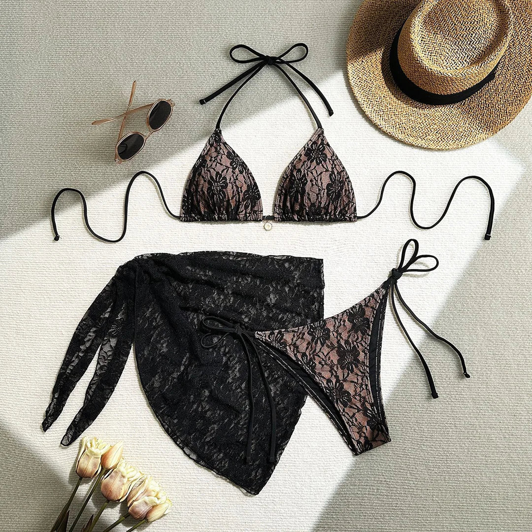 Three-piece bikini set featuring a lace halter top, high cut bikini bottoms, and mesh sarong in solid colors for an elegant and alluring beach look.