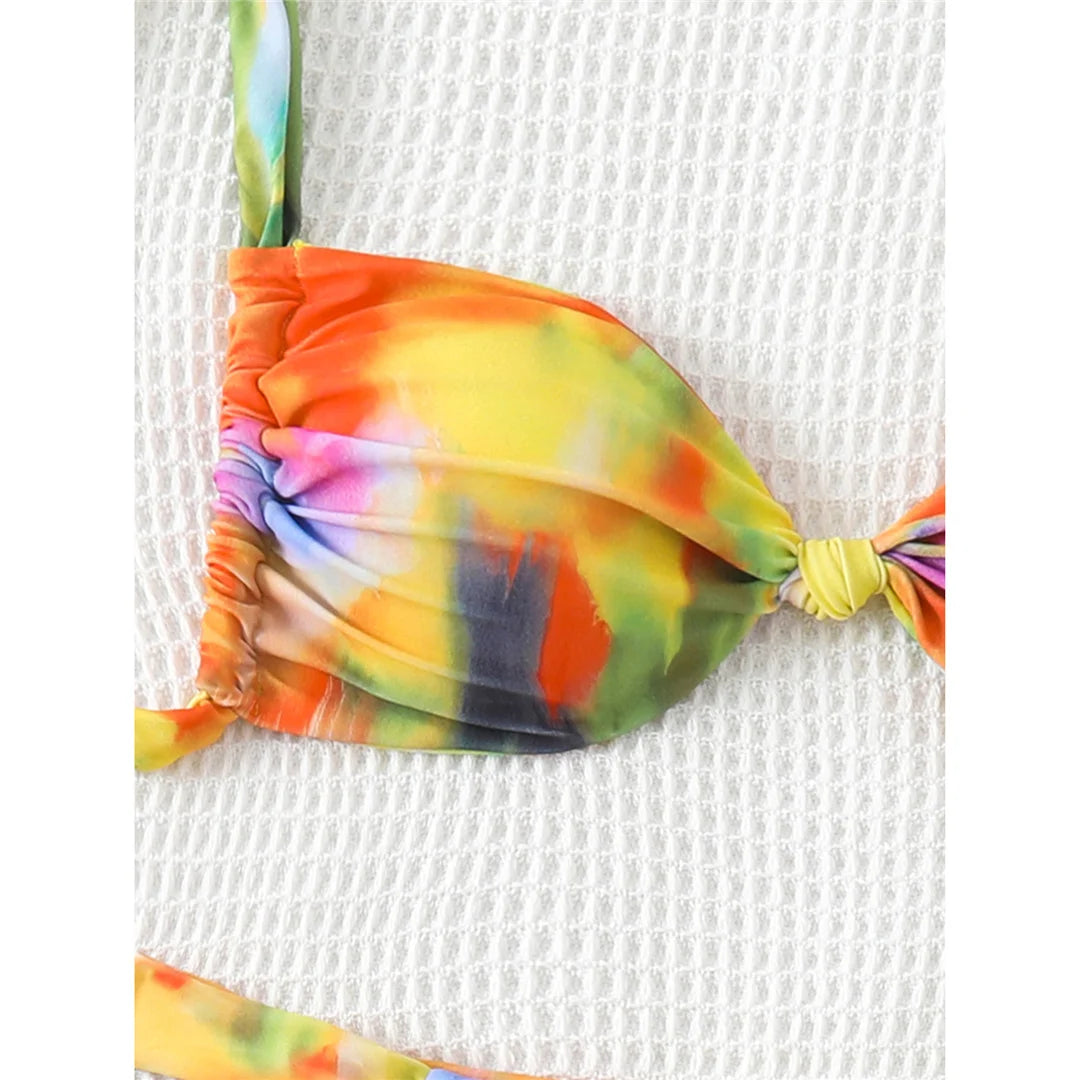 Printed tie-dye high-leg bikini set with vibrant pattern and padded design for a fun and flattering look for women.