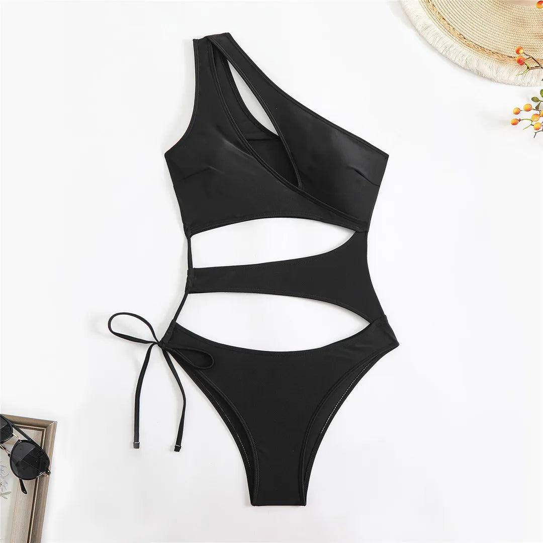Cut out asymmetric one shoulder one piece swimsuit in red, black, and coffee with high leg design.