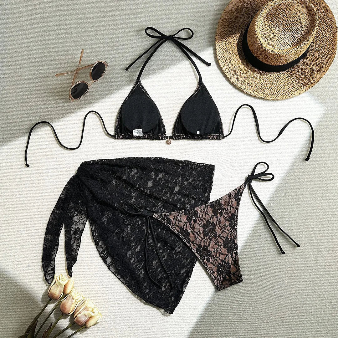 Three-piece bikini set featuring a lace halter top, high cut bikini bottoms, and mesh sarong in solid colors for an elegant and alluring beach look.