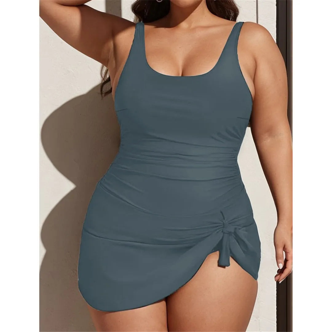 Backless solid padded plus size one piece swimsuit for women with adjustable straps and sophisticated design in monochrome colors.