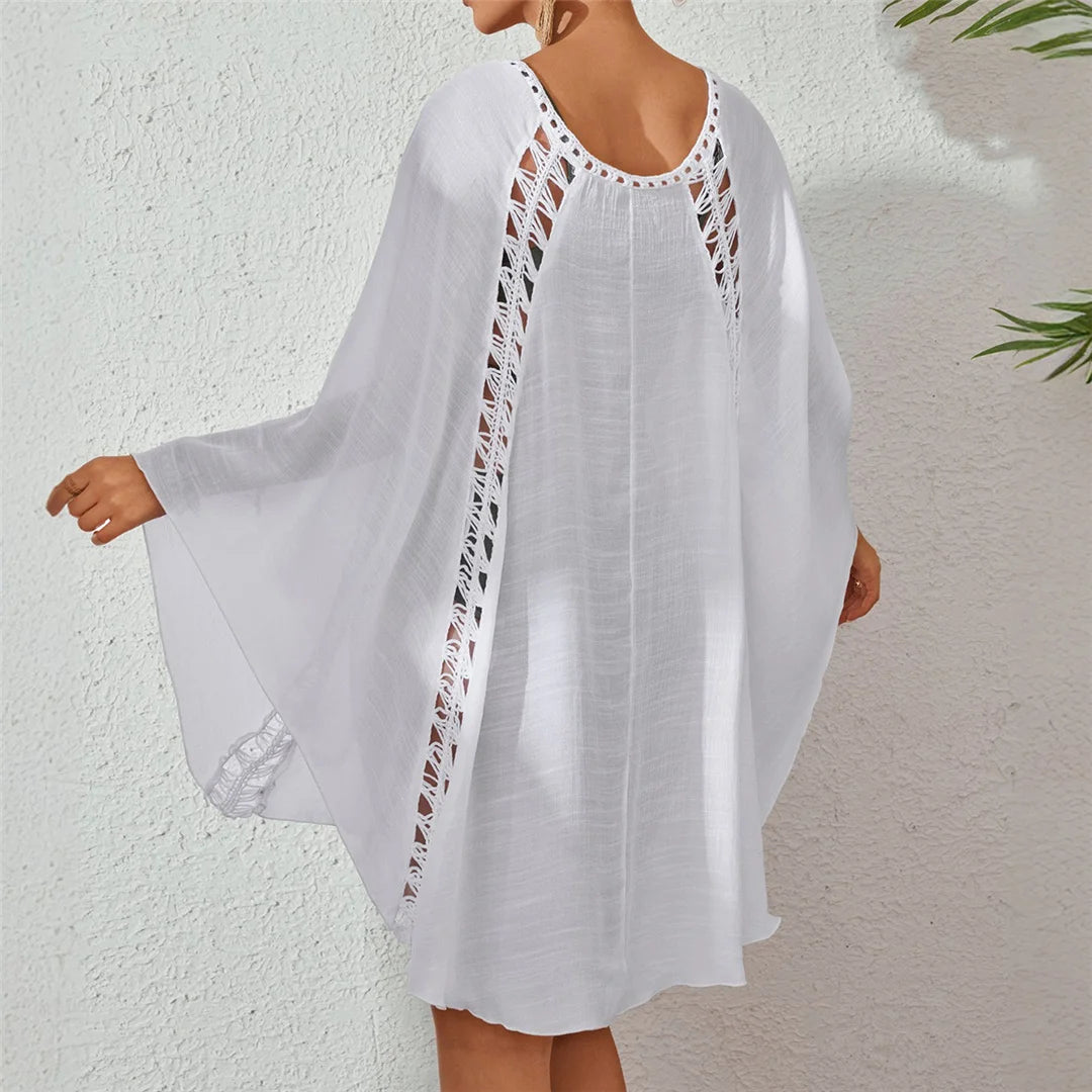 White long sleeve cut-out crochet knitted tunic beach cover-up with elegant design for women.