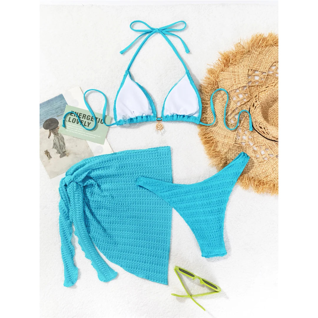 Halter wrinkled bikini three-piece set in solid blue, including a matching sarong, crafted from polyester and spandex.