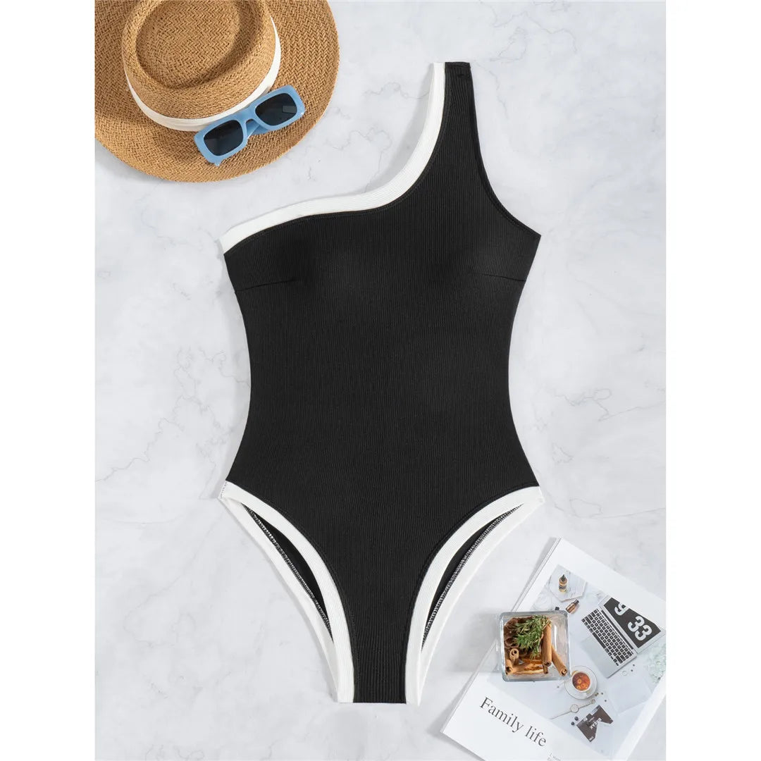 One-shoulder ribbed high-cut leg one-piece swimsuit with splicing design and padded support for women.