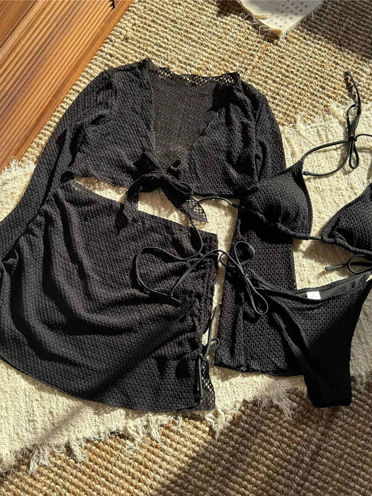 Long sleeve halter bikini four-piece set for women with chic mix-and-match options, including solid low waist design and matching skirt.