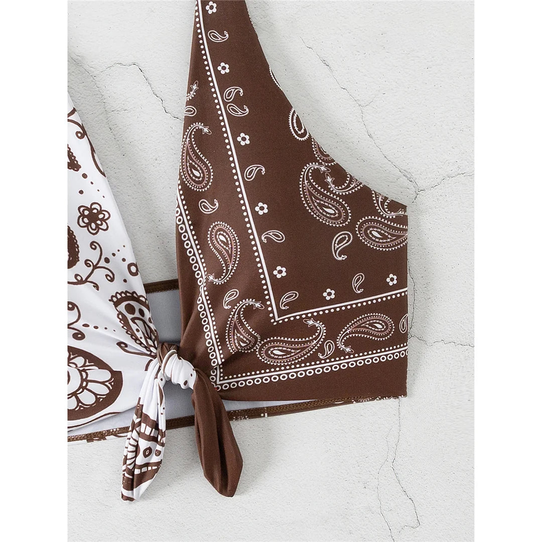 Printed splicing halter knotted bikini top with unique print combination in brown and white, made from polyester and spandex.
