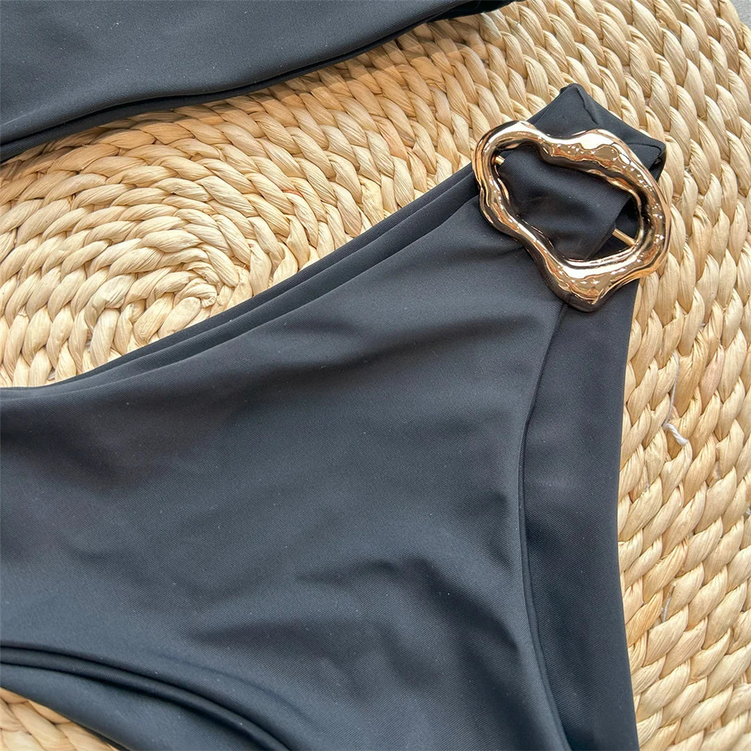 Asymmetric Metal Ring Swimsuit with stylish ring embellishments, monochrome solid color, polyester and spandex blend, adjustable shoulder straps, perfect for modern beach fashion.