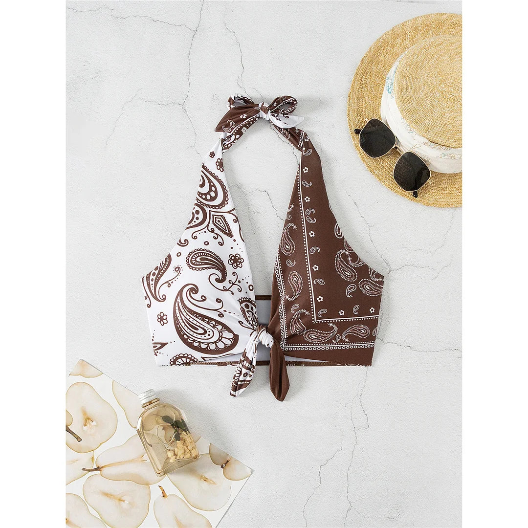 Printed splicing halter knotted bikini top with unique print combination in brown and white, made from polyester and spandex.
