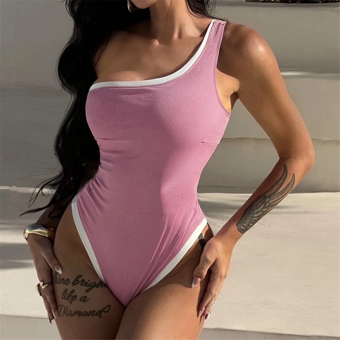 One-shoulder ribbed high-cut leg one-piece swimsuit with splicing design and padded support for women.