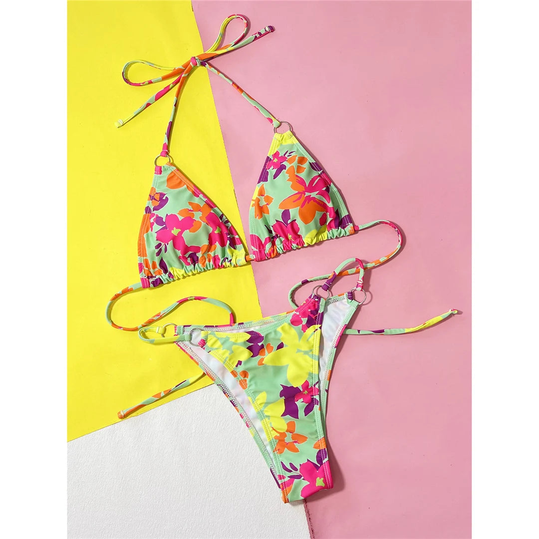Vibrant Colorful Flowers Printed Halter Bikini Set designed for a standout look. Adjustable halter top style two-piece swimsuit in a lively floral print. Ideal beachwear offering both style and functionality. Made from Nylon and Spandex, fitting true to size. Available for women in sizes S, M, L. Colors: Multicolor.