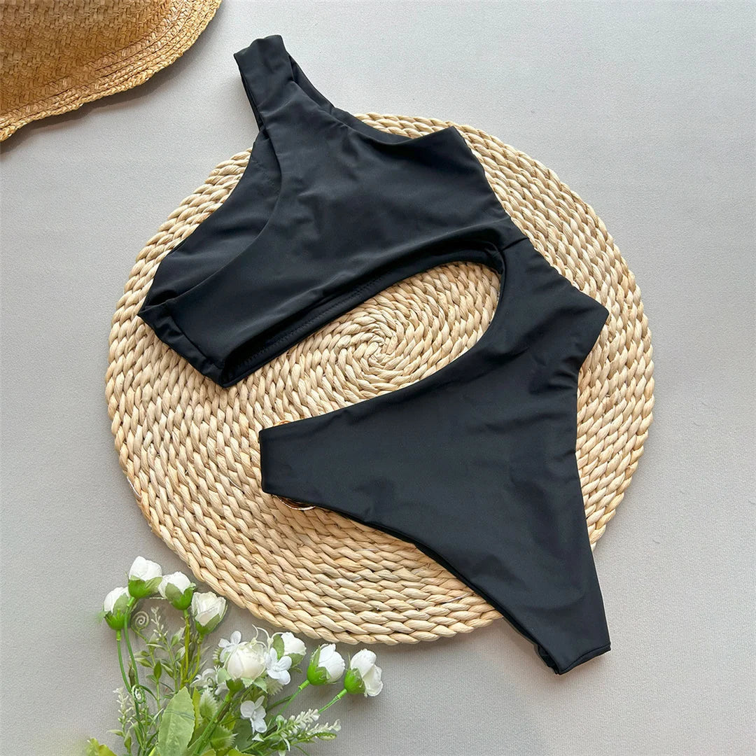 Asymmetric Metal Ring Swimsuit with stylish ring embellishments, monochrome solid color, polyester and spandex blend, adjustable shoulder straps, perfect for modern beach fashion.