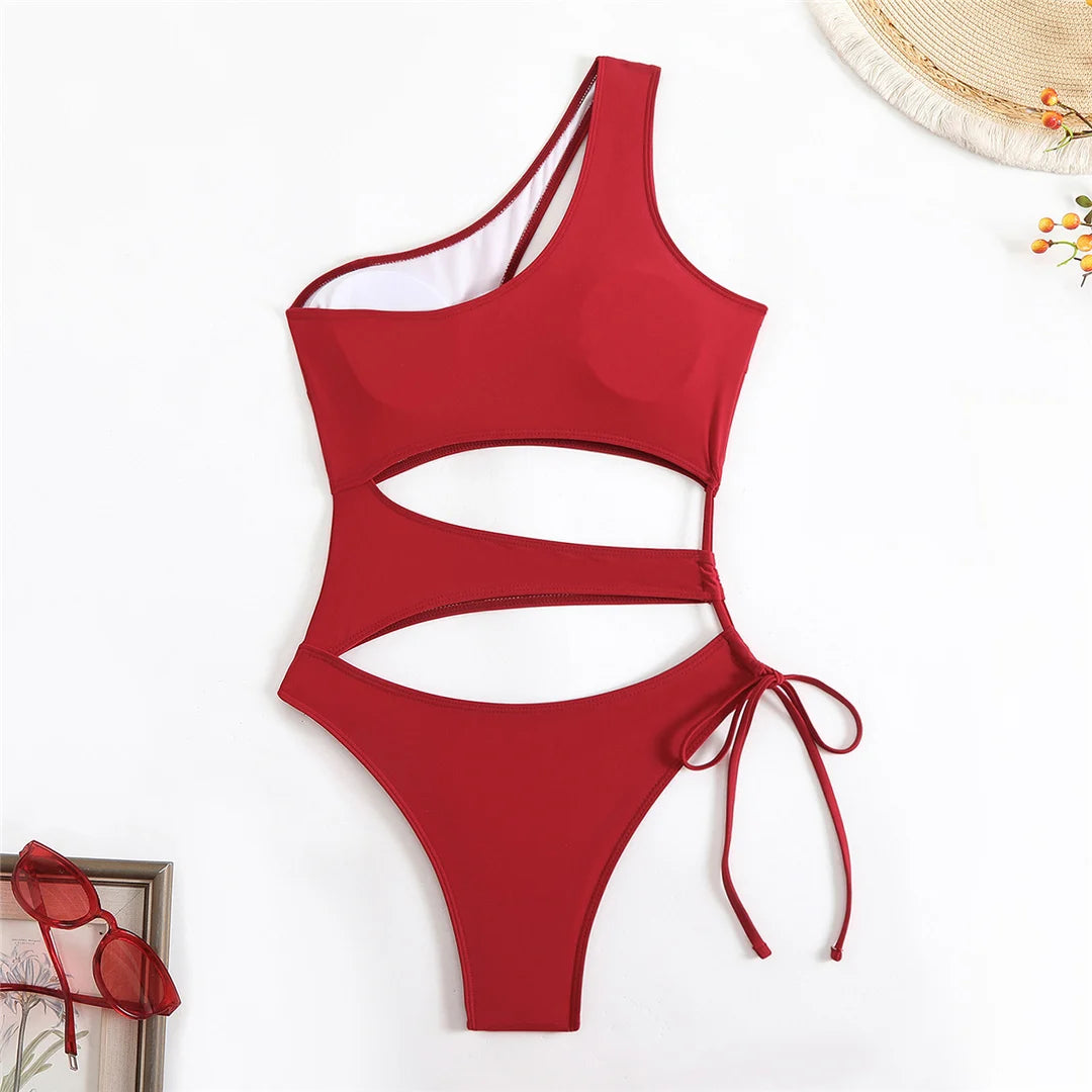 Cut out asymmetric one shoulder one piece swimsuit in red, black, and coffee with high leg design.