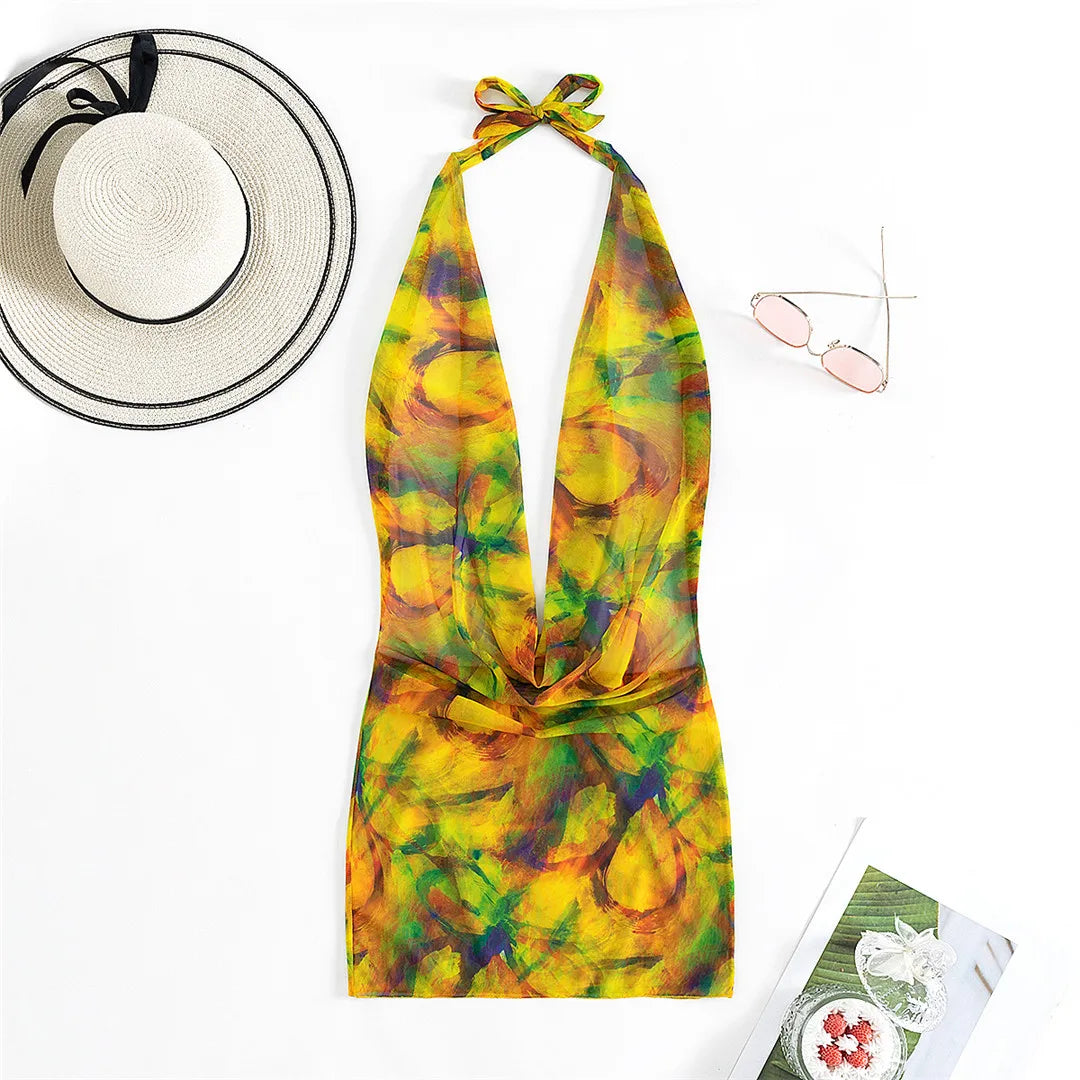 Captivating Printed Halter Tunic Beach Cover-Up with Backless Design, Made from Nylon, Polyester, Rayon, and Cotton. Ideal for Women Aged 25-34, Offering a Chic Layer of Coverage With a Multicolor Design of Orange and Yellow. Fits True to Size and is New and in Stock.