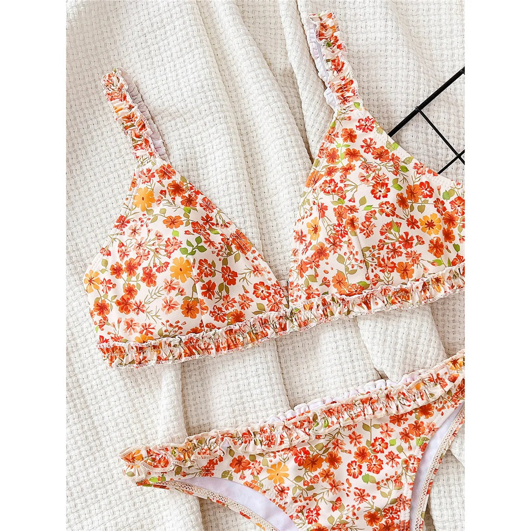 Flowers printed ruffled Brazilian bikini set, vibrant floral design, polyester spandex blend, wire-free support, low waist, women's two-piece swimwear, charming and feminine style.
