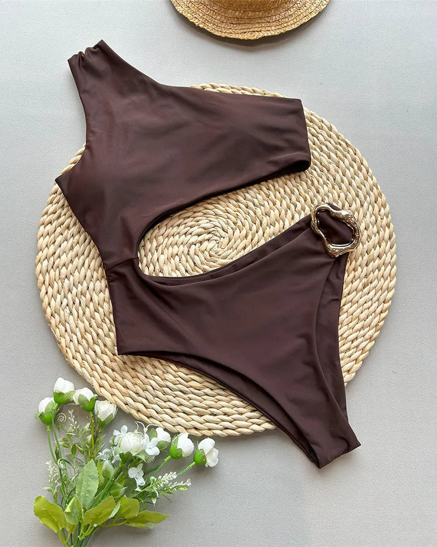 Asymmetric Metal Ring Swimsuit with stylish ring embellishments, monochrome solid color, polyester and spandex blend, adjustable shoulder straps, perfect for modern beach fashion.