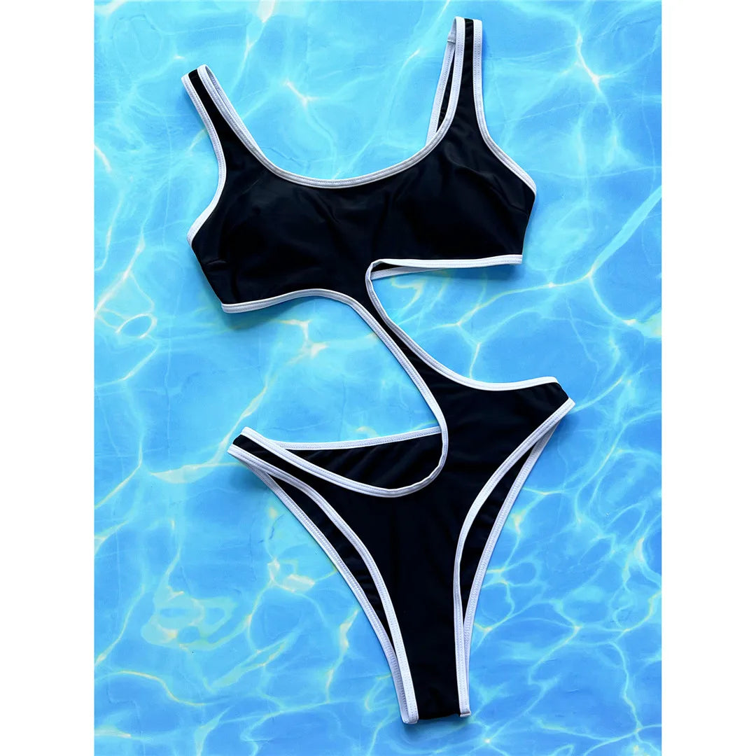 Modern Asymmetric Tummy Cut Out One Piece Swimsuit in Black. Designed with a flattering high leg cut and padded support, this swimsuit made of nylon and spandex fits true to size. Featuring a unique tummy cut-out, this one-piece is wire-free and perfect for women. It's a captivating piece that combines comfort with contemporary style, perfect for those who desire a balance of unique design and classic appeal.