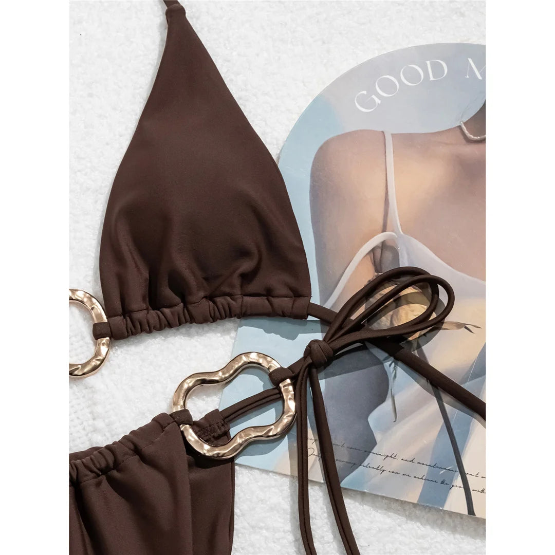Halter high-leg cut bikini set with striking metal ring accents for a sleek and modern beach look for women.