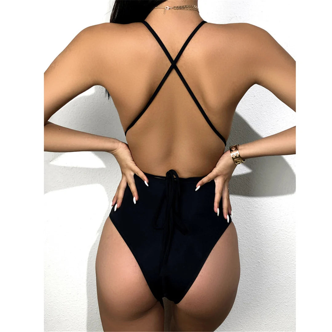 Sophisticated Splicing Wrap Around One Piece Swimsuit for Women, Featuring Dynamic Patchwork Pattern and Sensuous Wrap Around Style, Made from Nylon and Spandex, Fits True to Size, Tummy Cut-Out and Cross Back Design for Allure and Support, Available in Sizes S, M, L, and XL, Perfect for Contemporary Poolside Aesthetics, Comes in Classic Black Color
