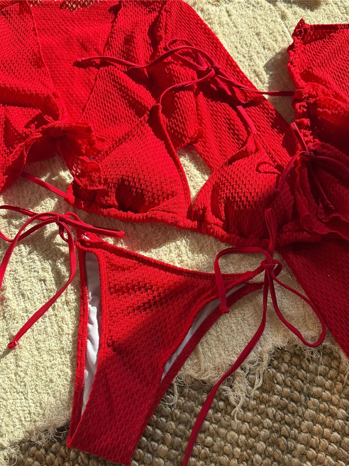 Long sleeve halter bikini four-piece set for women with chic mix-and-match options, including solid low waist design and matching skirt.