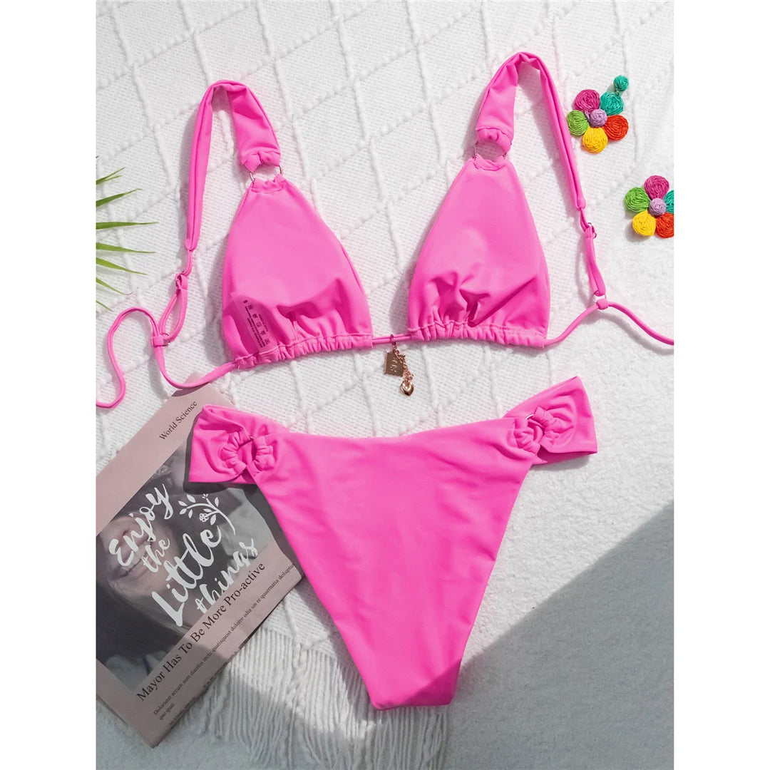 High-leg cut bikini set with stylish metal ring details and padded design for a chic and modern swimwear look for women.