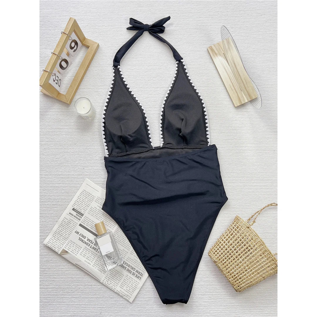 Halter wrinkled monokini in black, featuring a V-neck and adjustable straps, crafted from polyester and spandex.