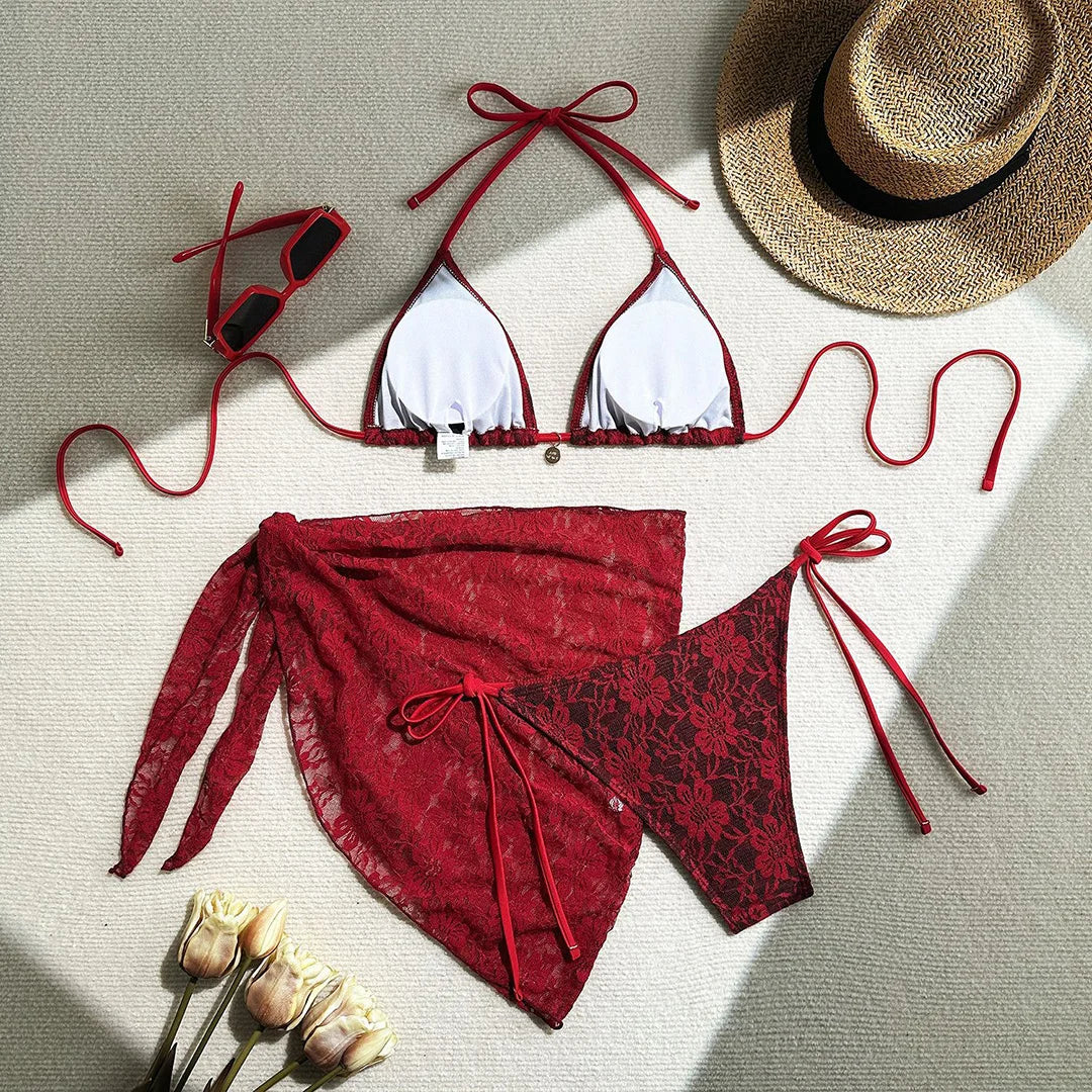 Three-piece bikini set featuring a lace halter top, high cut bikini bottoms, and mesh sarong in solid colors for an elegant and alluring beach look.