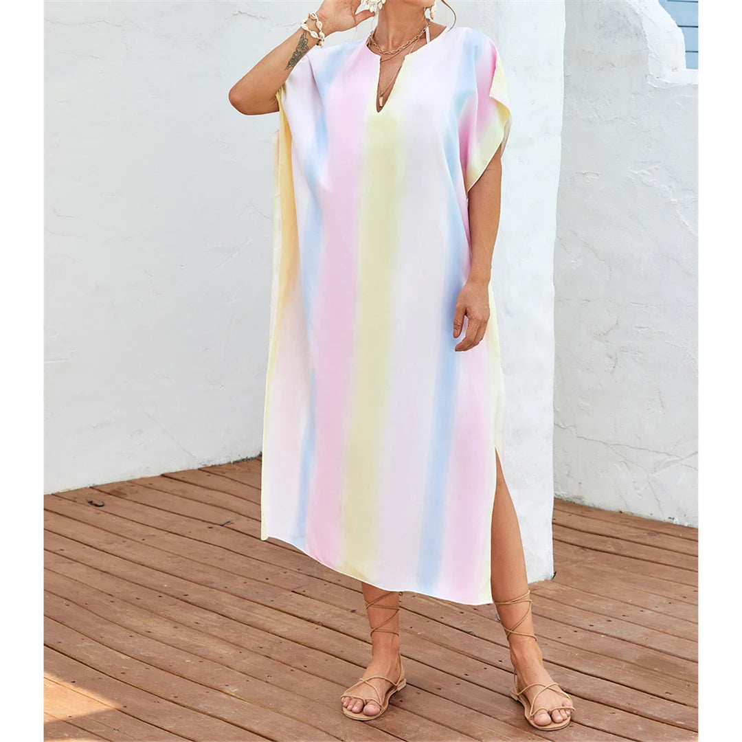 Rainbow Colorful Beach Cover-Up Tunic for women in multicolor. This short-sleeve, long beach dress with a relaxed fit is made from nylon, polyester, rayon, and cotton. It is perfect for adults aged 18-35, fits true to size, and is available in Sizes S, M, L. This product is in stock and offers free shipping.