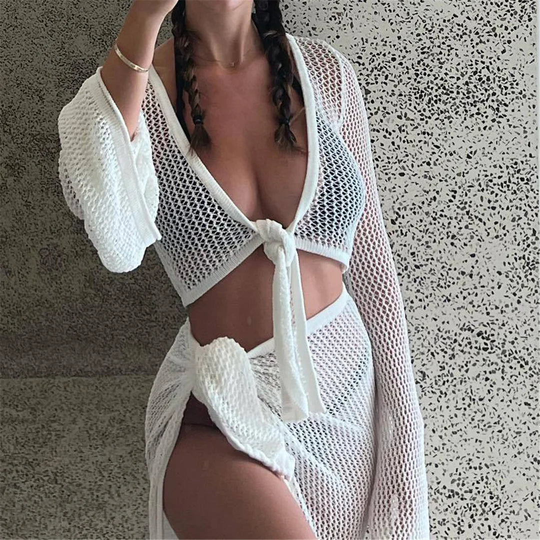 See-through crochet tunic with long sleeves, charming hollow-out design, beach cover-up, solid pattern, polyester, elegant beachwear for women.