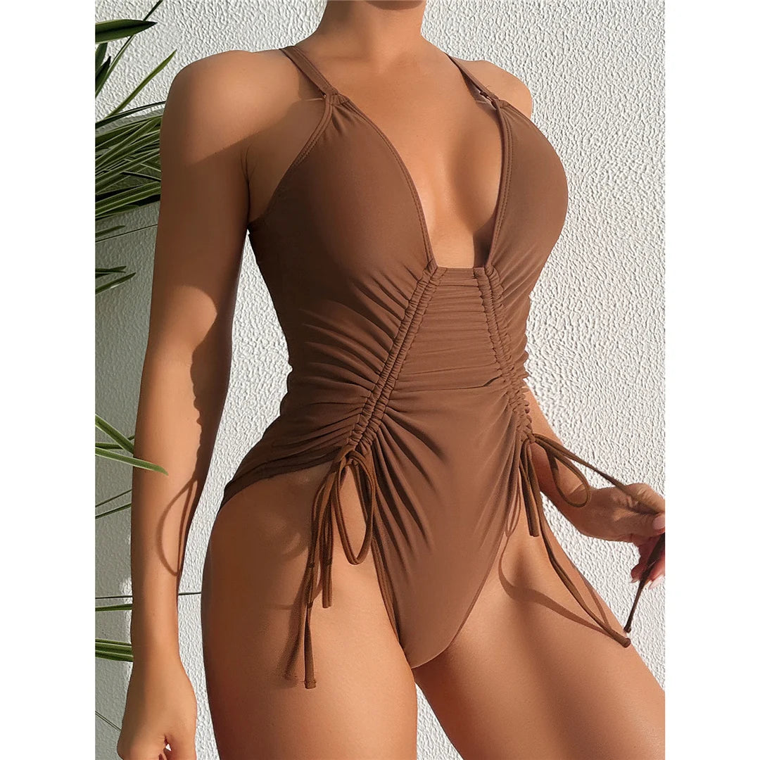 V neck lace-up cross back one piece swimsuit with wrinkled texture and high cut design in solid dark brown.