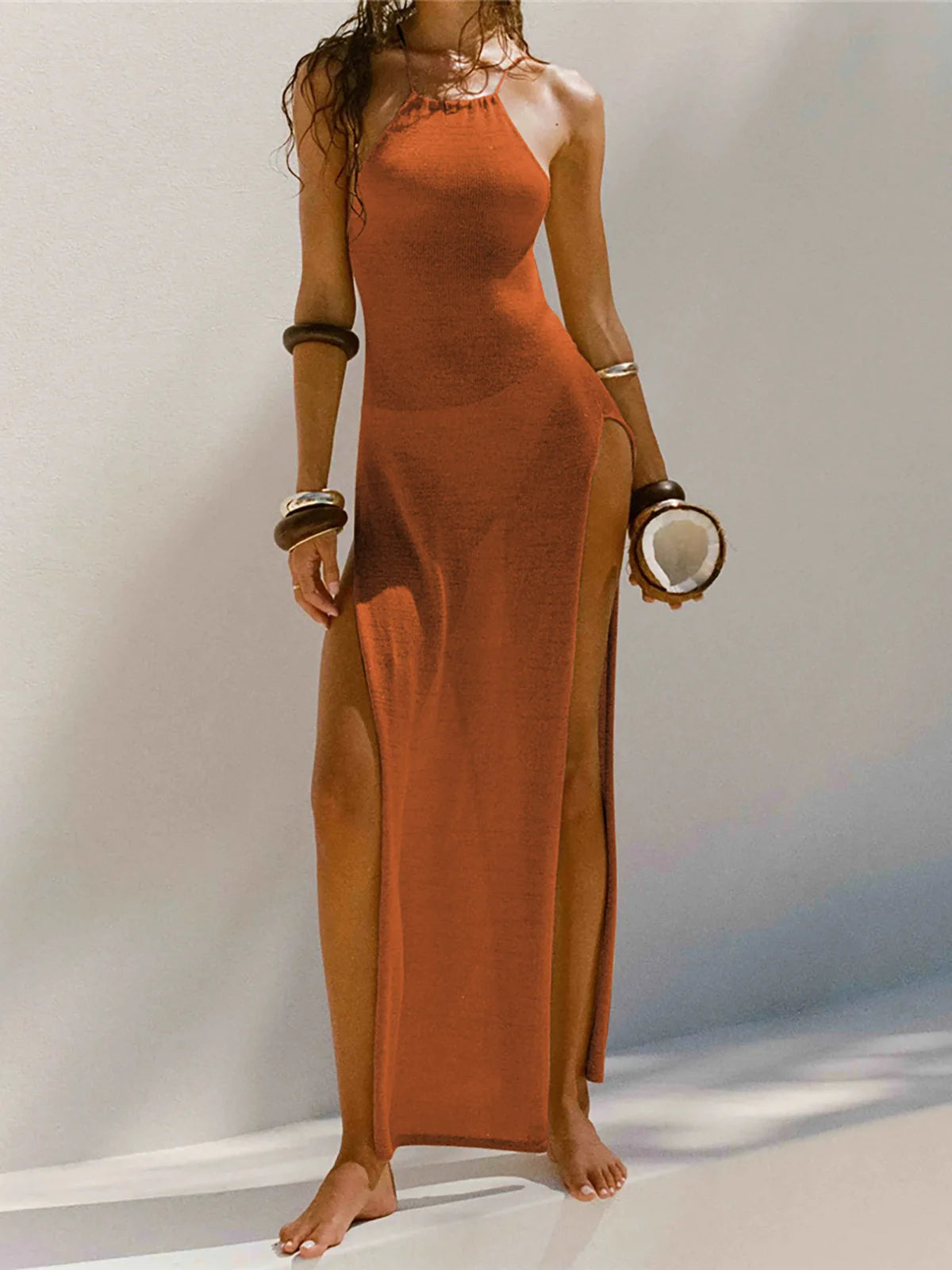 High Slit Crochet Dress with backless design and intricate knit pattern. Made of Nylon, Polyester, Cotton, this beach cover-up is perfect for summer with its medium stretch, sleeveless, ankle-length silhouette. Comes in a slim fit with a pull-over closure type. Available in sizes S, M, and L and colors Hot Pink, Green, Black, Peacock Blue, Purple, Red, White, Light Gray, Light Blue, Beige, Dark Khaki, and Orange. A must-have for an elegant, free-spirited beach style.