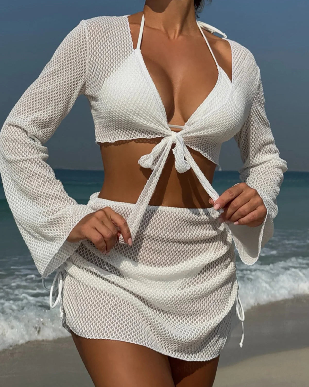 Long sleeve halter bikini four-piece set for women with chic mix-and-match options, including solid low waist design and matching skirt.