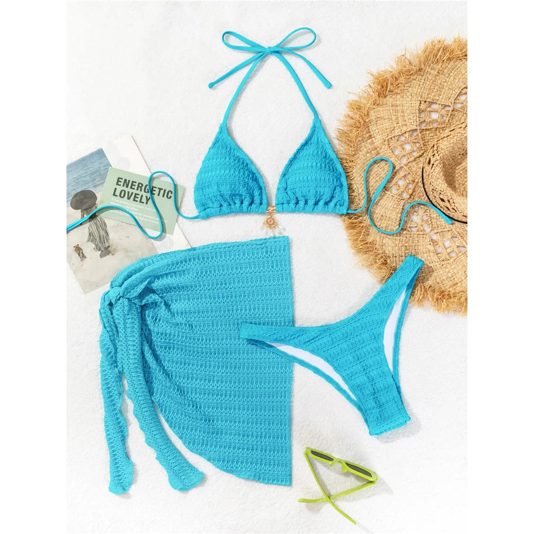Halter wrinkled bikini three-piece set in solid blue, including a matching sarong, crafted from polyester and spandex.