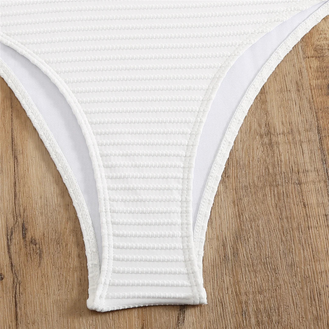 Embrace unique style with a cut out asymmetric one shoulder one piece swimsuit, offering elegance and boldness through its high leg cut design. Featuring strategic cut outs, a padded fit, and adjustable shoulder strap for maximum comfort and support. Made from polyester, spandex, and polyamide, this monochrome solid pattern is ideal for those making a fashion statement on the beach or poolside. Available in black and white.