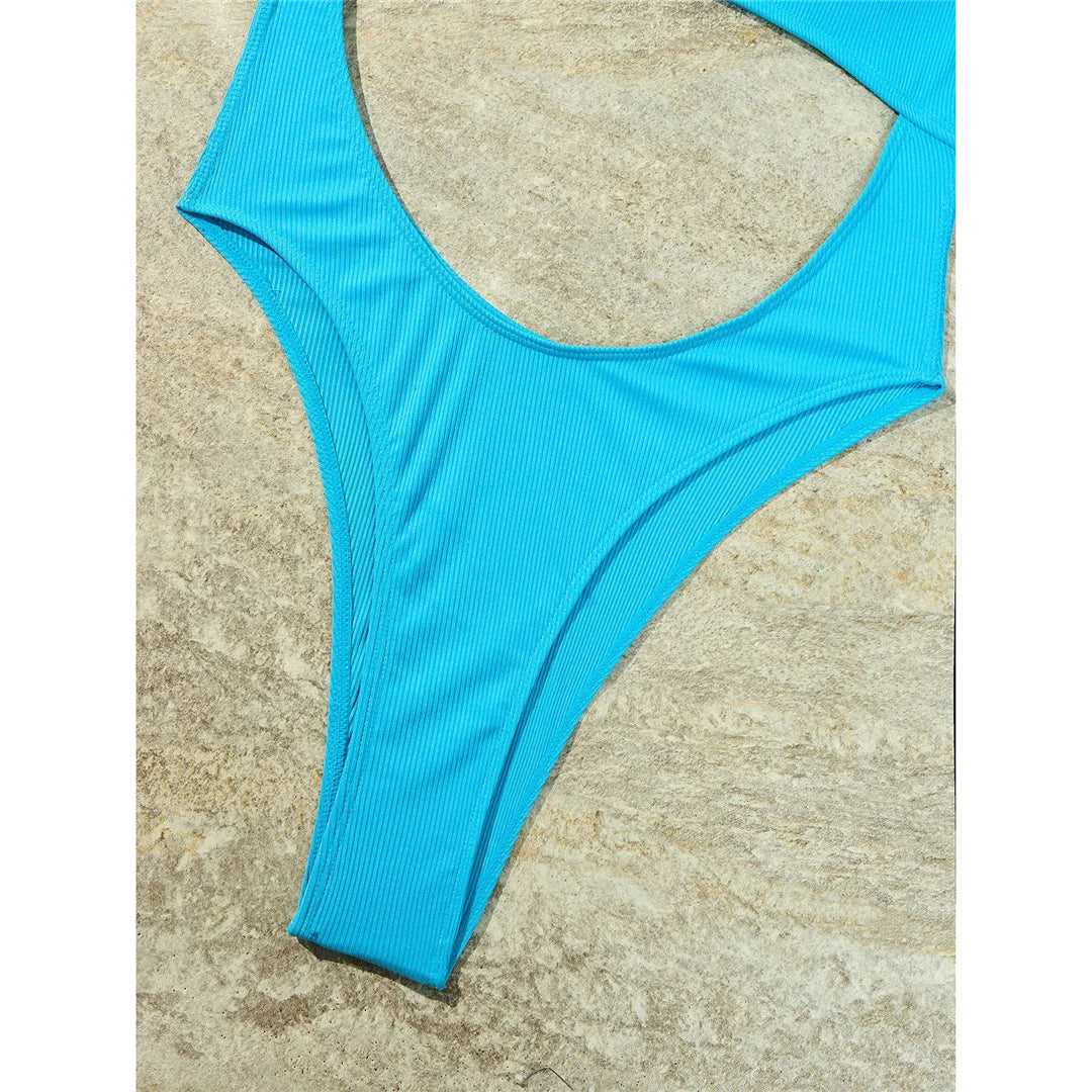 Alluring One-Piece Swimsuit for Women with a Ribbed Texture and Tummy Cut-Out Design, Features Backless Detail and High Leg Cut, Padded for Enhanced Support, Crafted from Nylon and Spandex, Fits True to Size, Available in Solid Blue, Black, and Red.