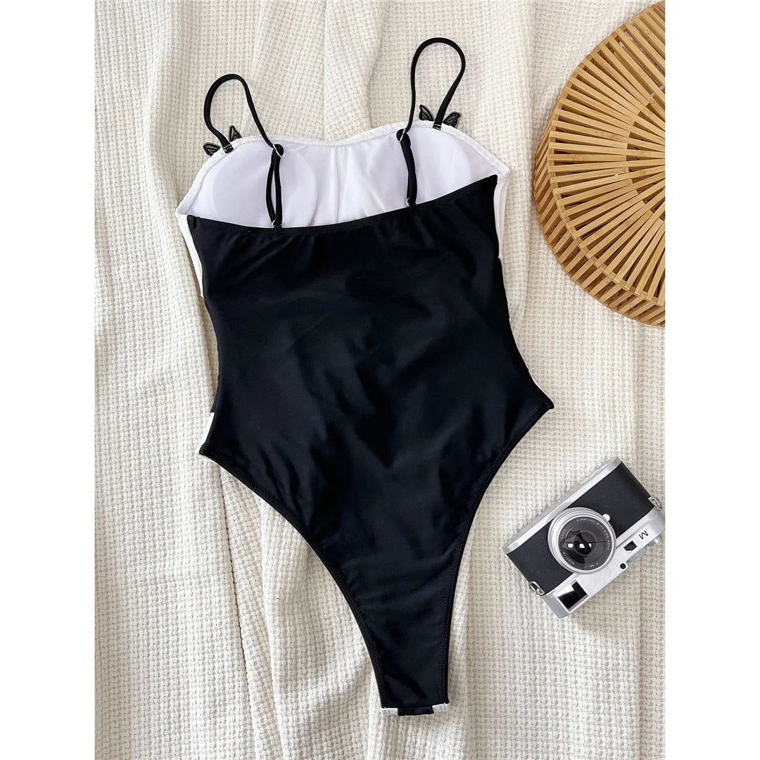 Splicing cut-out ribbed one-piece swimsuit, high-leg padded design, adjustable triangle top, polyester spandex blend, monochrome patchwork pattern, women's swimwear.