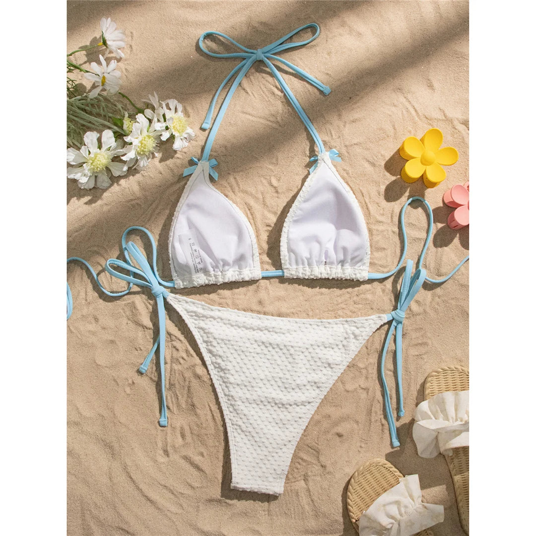 Halter high-leg cut bikini set with bow and strappy details for a playful and flattering swimwear option for women.