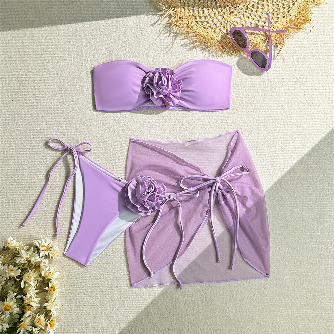 Elegant 3D Flowers Bandeau Bikini with Sarong, Three Piece Women&#39;s Swimwear in Pink, Purple, and Blue, Made from Soft Nylon and Spandex, Wire Free Support with Padding, Features Low Waist Bottoms and Fits True to Size. Sizes Available: S, M, L.