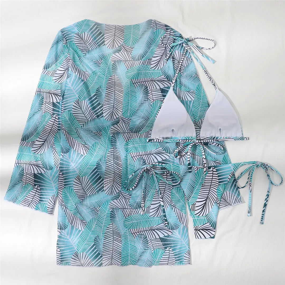 Women's Vibrant Three-Piece Leaves Printed Bikini Set with Chic Cover-Up. Made from Nylon and Spandex, it fits true to size and has a low waist wire-free design. Perfect for tropical escapes and summer adventures.