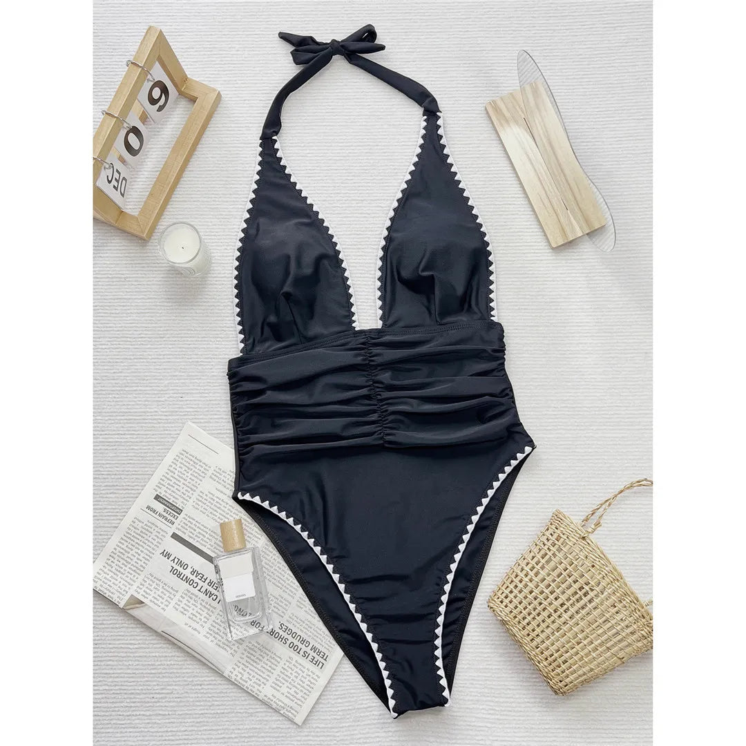 Halter wrinkled monokini in black, featuring a V-neck and adjustable straps, crafted from polyester and spandex.